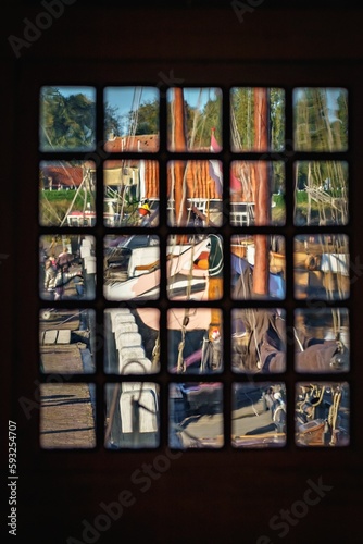 Wooden window with a vintage view of the old ship harbor outside