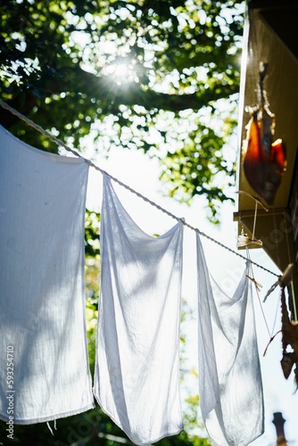 Laundry hangs in the sun on a wire © Fotografiecor Nl/Wirestock Creators