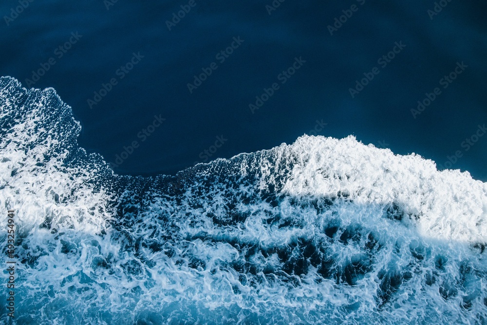 Fototapeta premium Aerial view of sea waves breaking beach