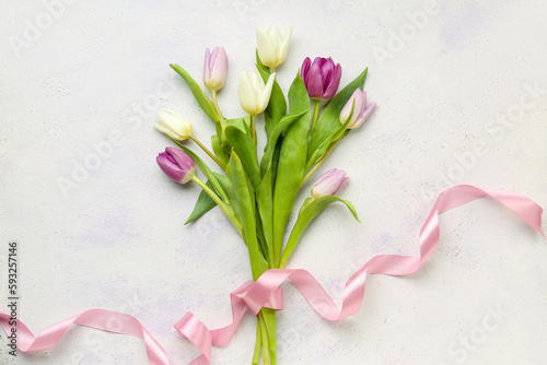 Fototapeta Naklejka Na Ścianę i Meble -  Beautiful tulips with ribbon on white background