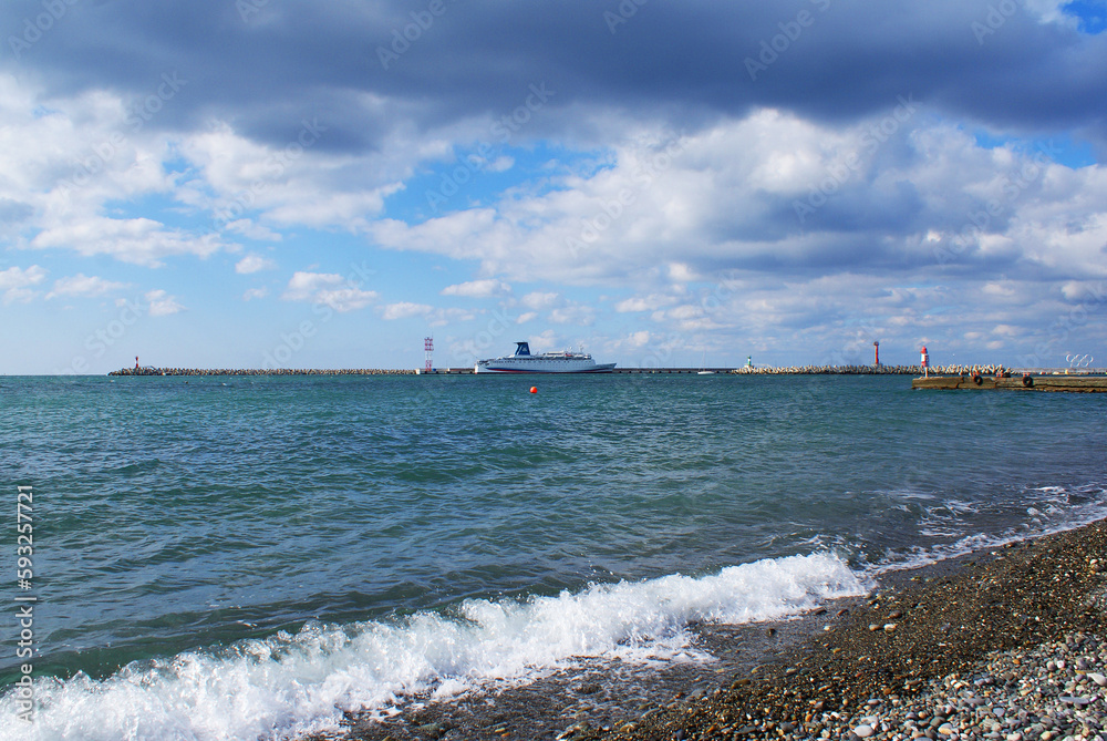 Seashore, sun glare on the water, pebbles on the seabed, nature. Background.