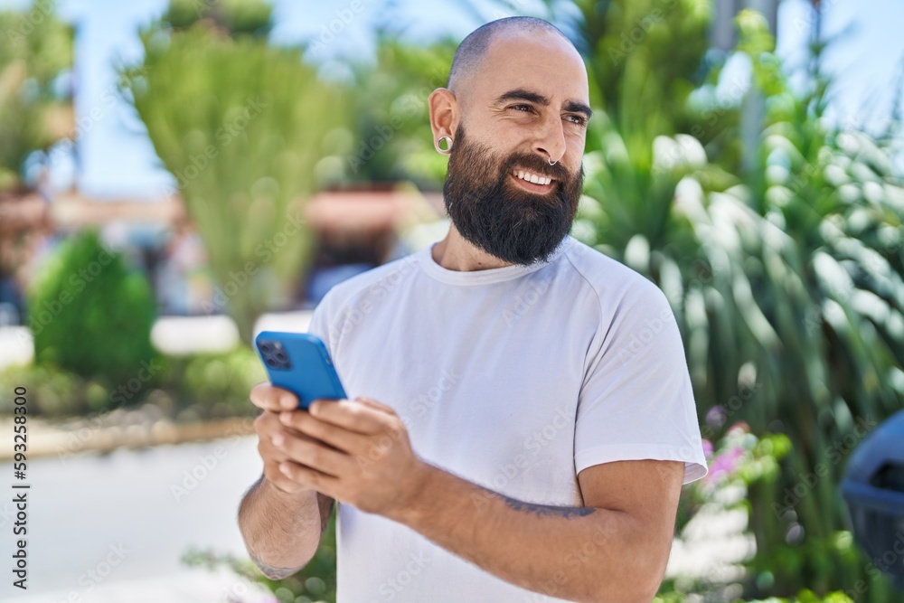 Young bald man smiling confident using smartphone at park Young bald man smiling confident using smartphone at park