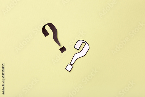 Paper question marks on yel...