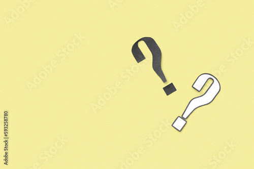 Paper question marks on yel...