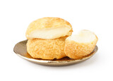 Plate with delicious choux pastry on white background