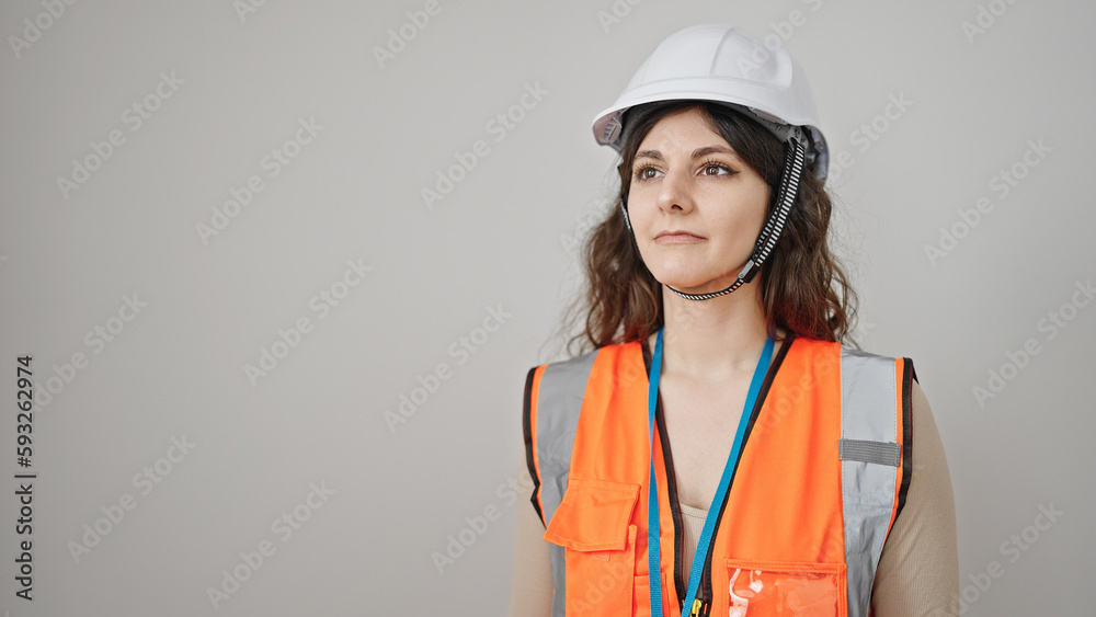 Young beautiful hispanic woman builder standing with relaxed expression over isolated white background Young beautiful hispanic woman builder standing with relaxed expression over isolated white background
