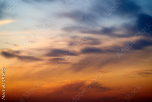 Sunset sky with red light of the setting sun. Evening clouds in the orange light of sunset rays © Андрей Журавлев