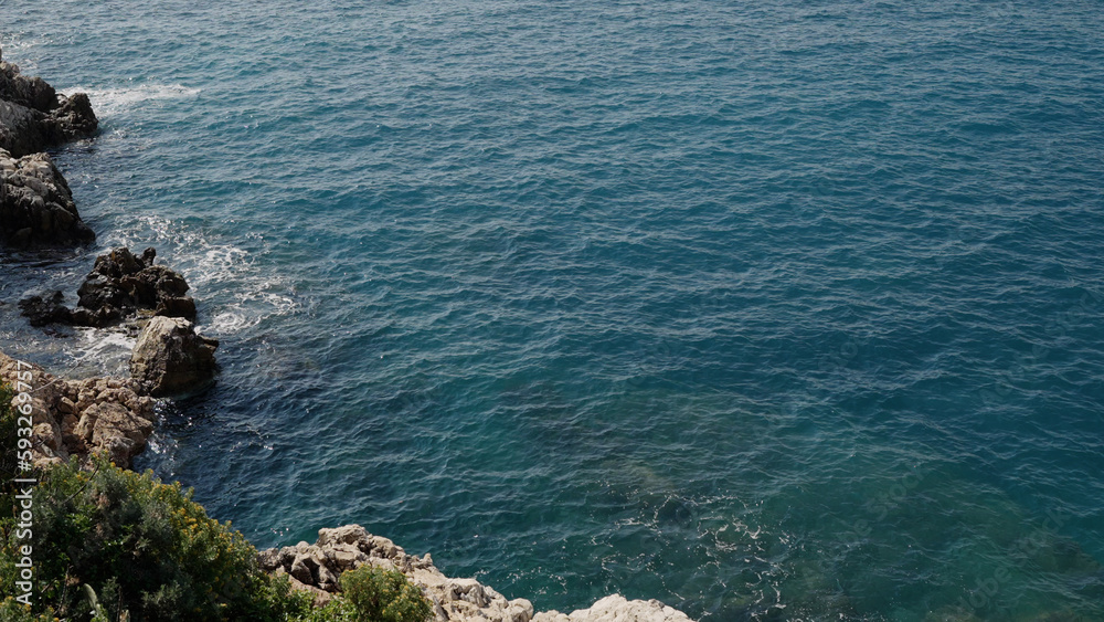 waves of mediterranean sea splashing on coastline of French Riviera