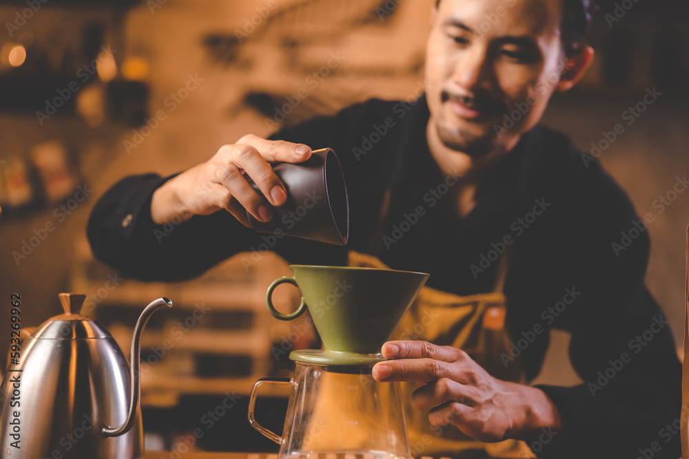 Professional barista preparing coffee using chemex pour over coffee