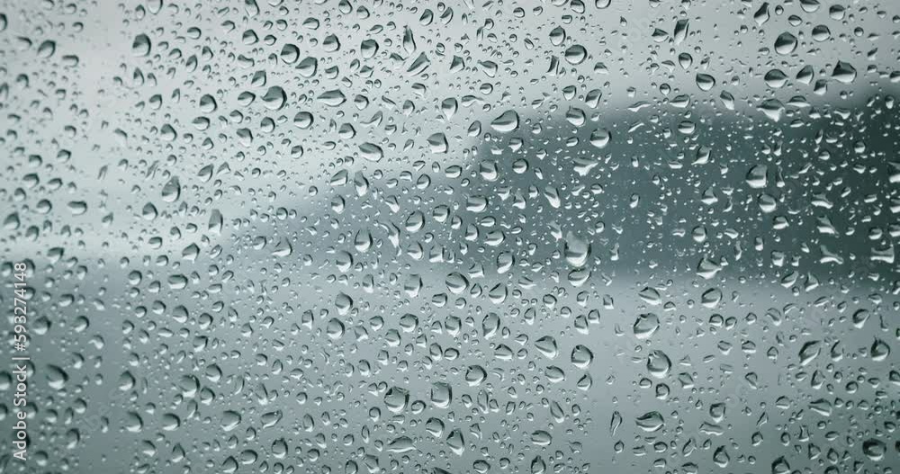 Raindrops on a window pane. Severe sea waves foam outside. Dramatic cloudy weather and rain. Calmness and pacification. Raindrops on a window pane. Severe sea waves foam outside. Dramatic cloudy weather and rain. Calmness and pacification.