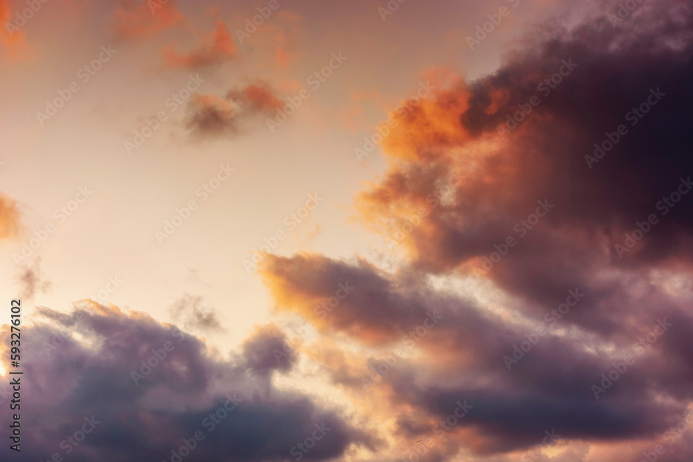 evening sky in orange glow. huge fluffy clouds. dramatic natural background