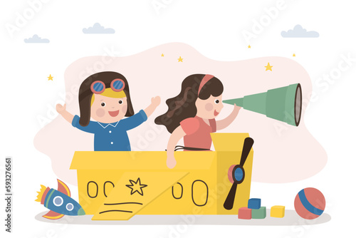 Cute kids sitting in cardboard box and playing airplane pilots. Children flies on an imaginary aircraft. Preschooler game, imagination, creativity and dreams.