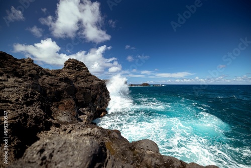 Wave crashing against the rocks © Mike40/Wirestock Creators
