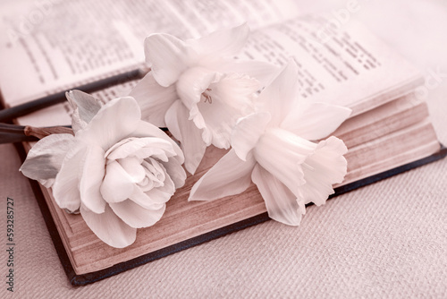 romantic card with a bouquet of tender spring flowers on an open book