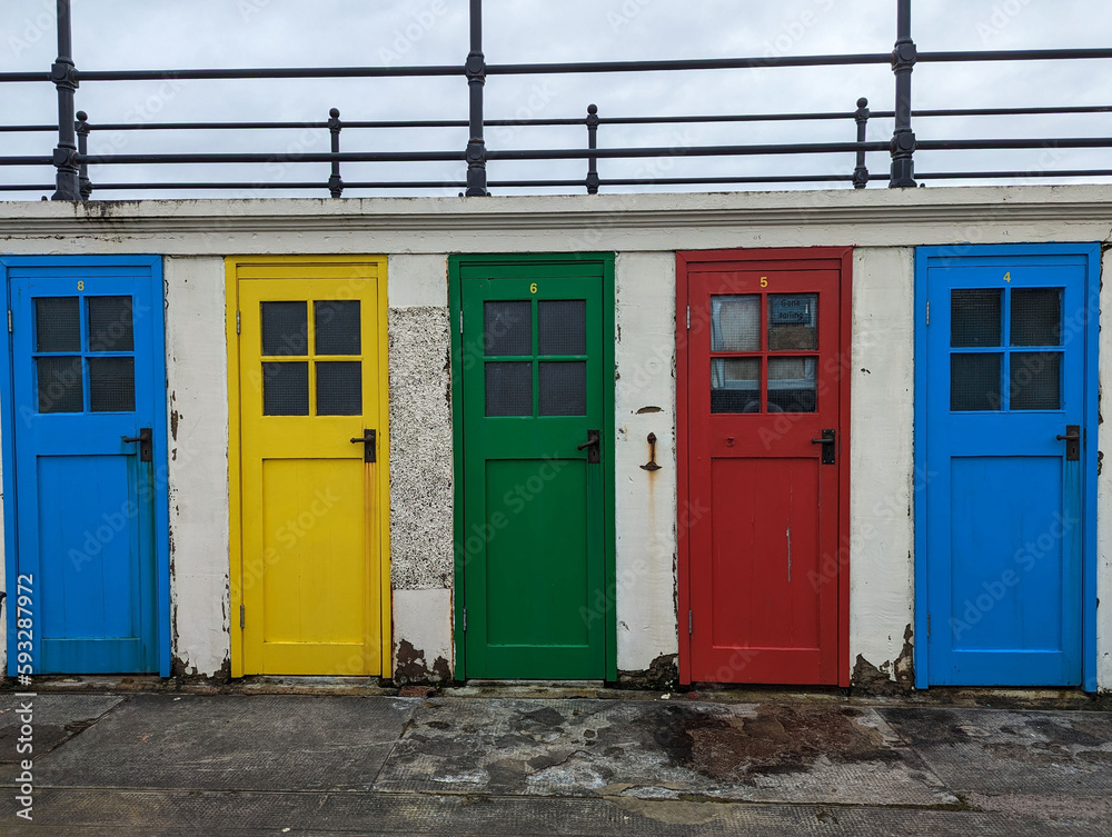 Colourful old doors to changing rooms for a disused lido or outside swimming pool in North Berwick, East Lothian, Scotland, UK.