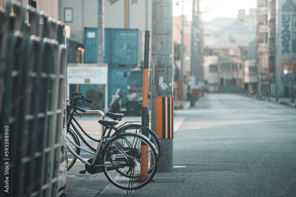 Selective focus of bicycles parked on the sidewalk on a sunny day in Chatan, Japan