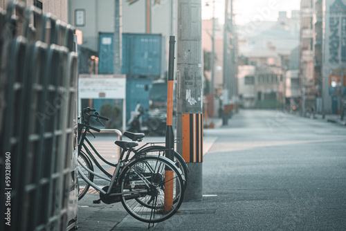 Selective focus of bicycles parked on the sidewalk on a sunny day in Chatan, Japan
