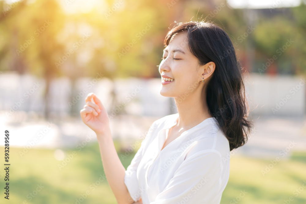 Portrait young beautiful asian woman with happy smile around outdoor park in sunny summer day Portrait young beautiful asian woman with happy smile around outdoor park in sunny summer day
