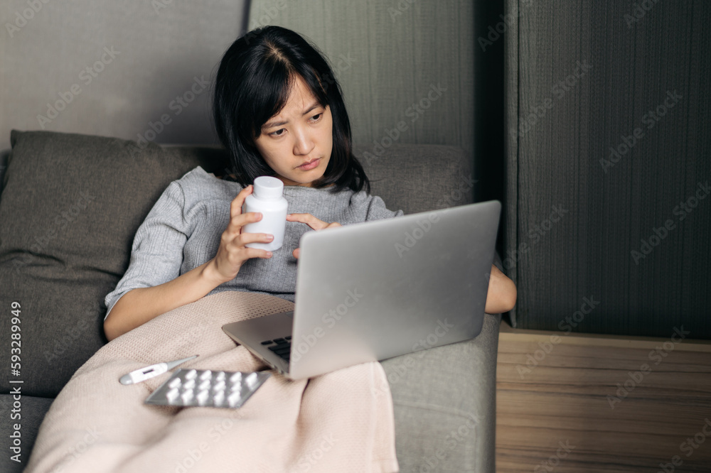 Sick asian woman with medicine having video call conference medical app in telehealth on laptop. Healthcare, technology and people concept Sick asian woman with medicine having video call conference medical app in telehealth on laptop. Healthcare, technology and people concept