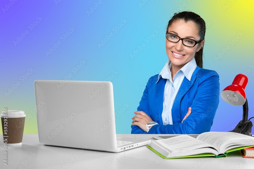 cheerful businesswoman at desk in office with computer cheerful businesswoman at desk in office with computer