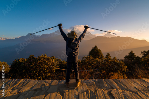 A young traveller trekking in Poon Hill view point in Ghorepani, Nepal.. photo