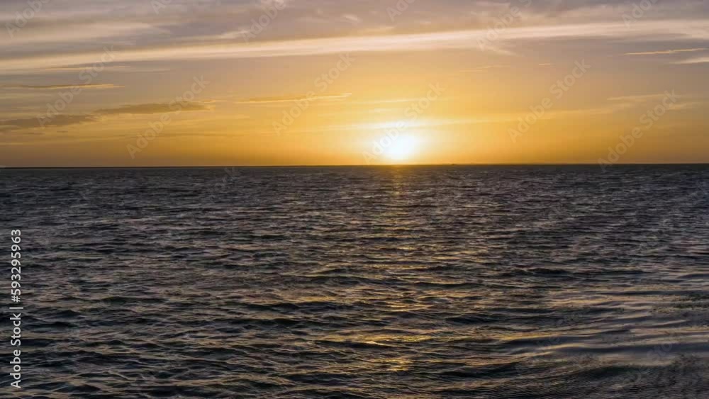Beautiful bright yellow sunset sky over a blue sea Beautiful bright yellow sunset sky over a blue sea