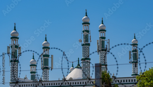 Blurred barbed wire in foreground at Habibia Soofie Masjid Mosque in Athlone near Cape Town South Africa photo