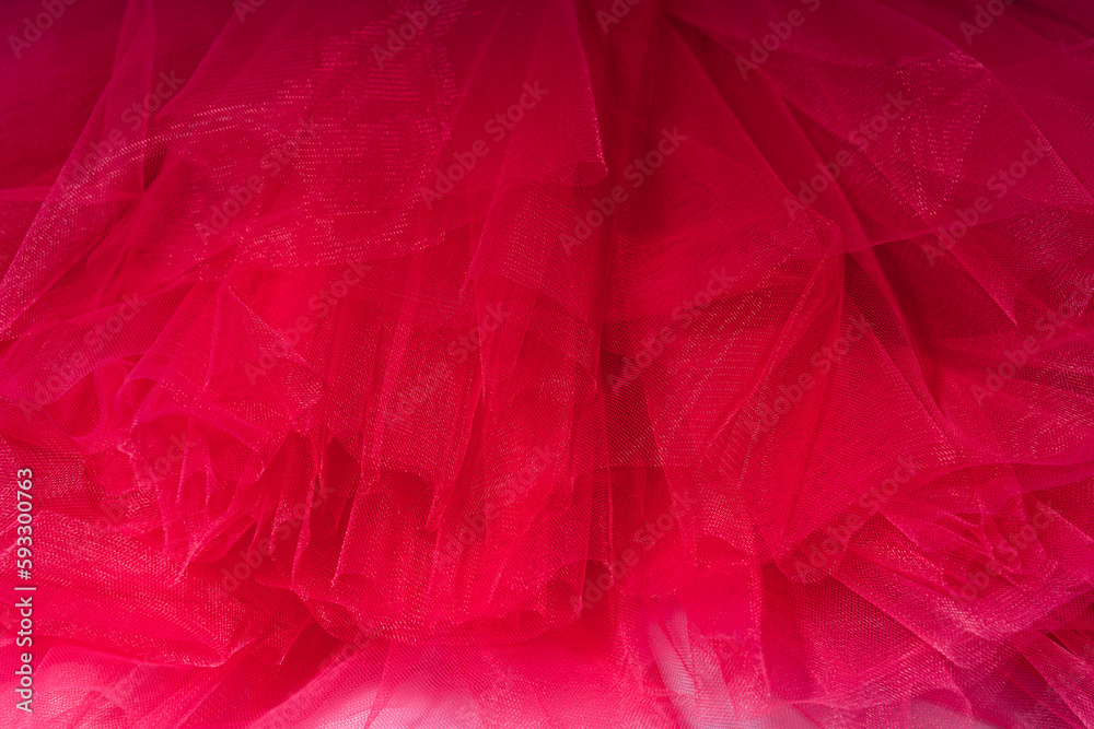 Obraz premium Red background of tulle fabric close-up.