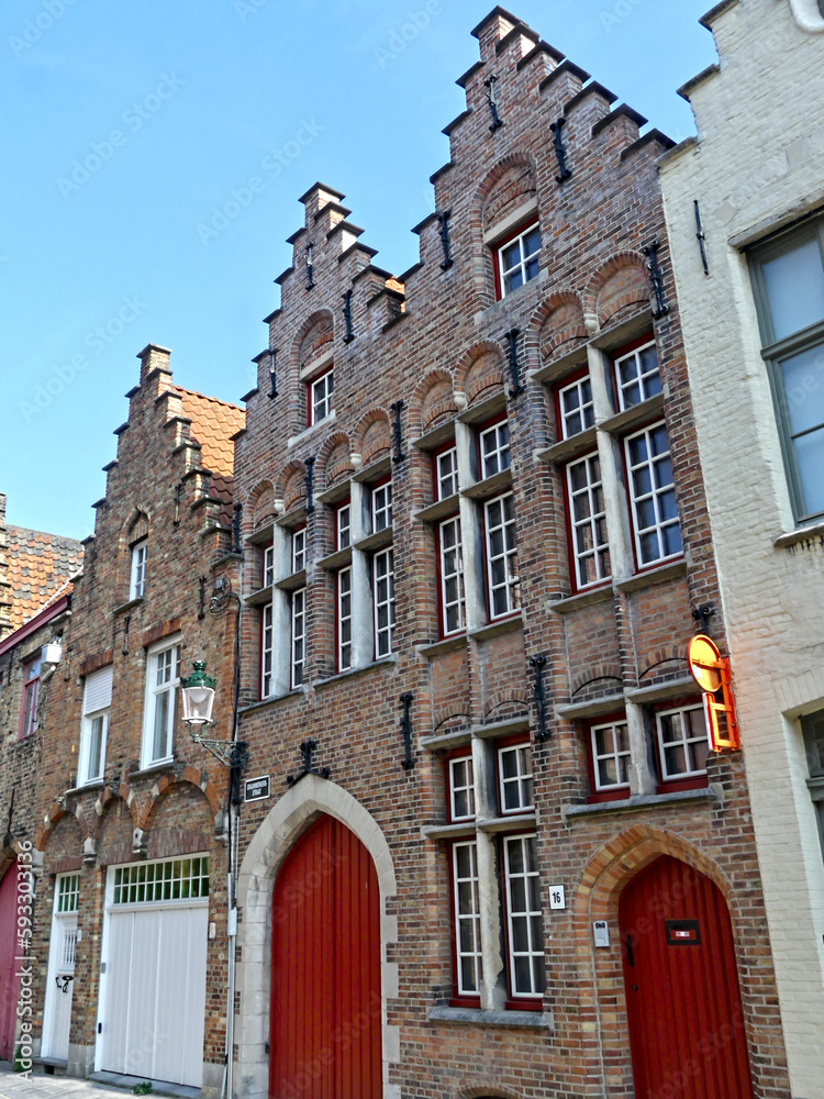 Fototapeta premium Bruges, April 2023: Magnificent facades of the buildings of Bruges, the Venice of the North