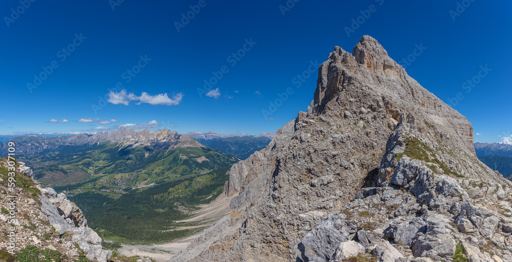 Panoramic view of famous Dolomites mountain peaks. Northern slope of Mount Latemar and in the background the Catinaccio massif, South Tyrol, Italy. Awesome mountain panorama