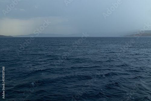 Scenic shot of the wavy sea surface under the stormy sky