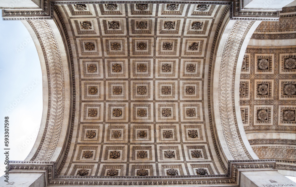 Architectural details of the Arc de Triomphe from a bottom view, Paris, France.
