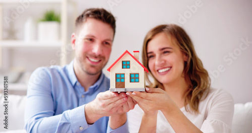 Happy Family Buying New House. Couple With Real Estate