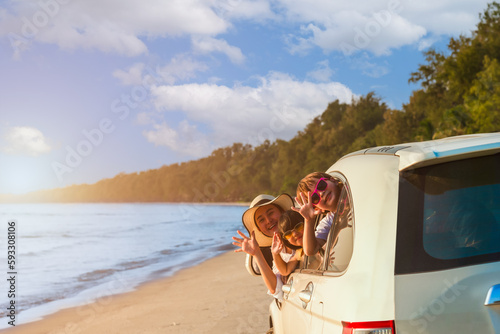 Happy Asian family with trip car travel having fun and enjoying on beach in summer vacation holiday.