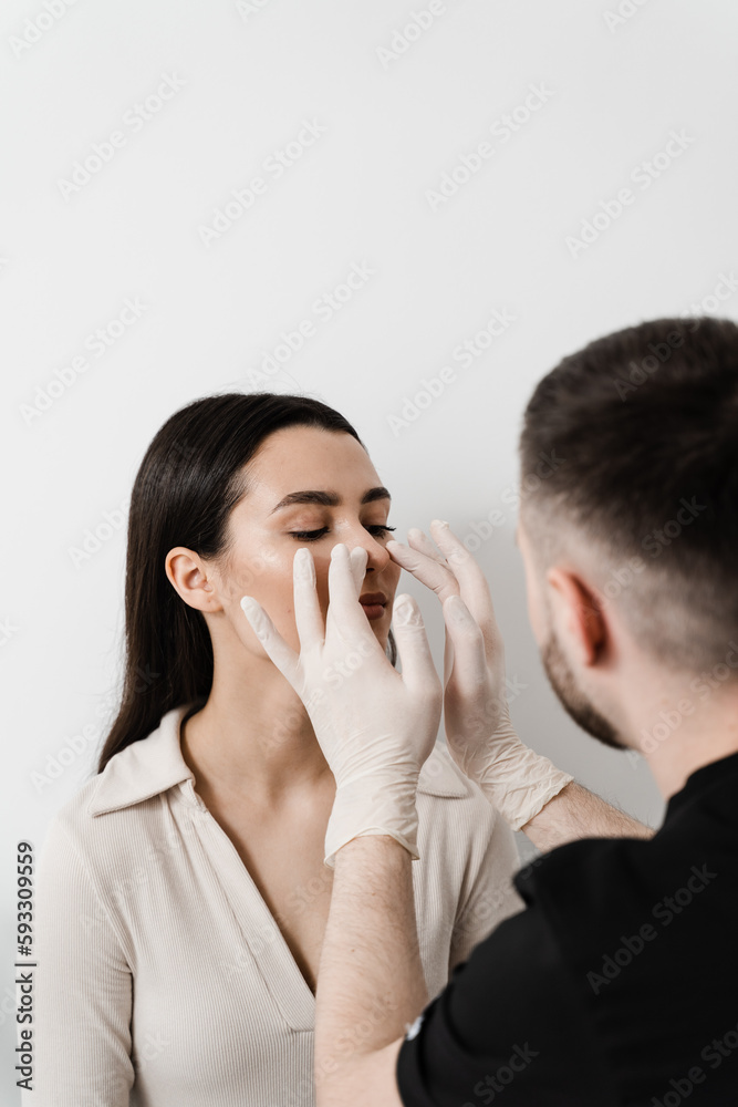 ENT doctor examines and palpates the nasal septum for septoplasty surgery. Septoplasty is the surgical correction of defects and deformities of the nasal septum.