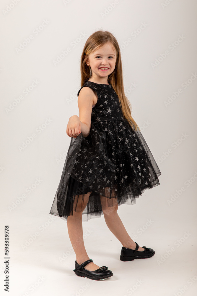 Portrait of cute smiling little girl in black princess fluffy dress. Portrait of cute smiling little girl in black princess fluffy dress.