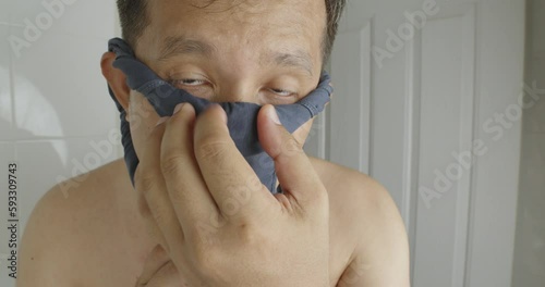 A man try to wearing underpants on his face for mask protective air smog pollution.