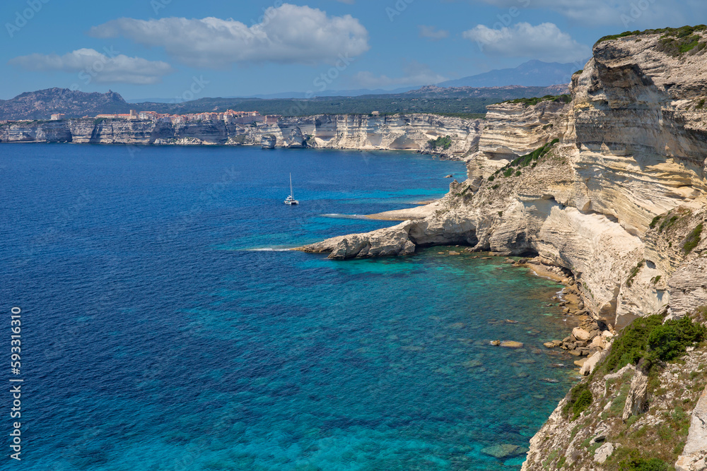Landscape view of the famous chalk cliffs of Bonifacio. The famous rugged chalk cliffs and turquoise blue sea coast at Bonifacio, Capo Pertusato, Corsica island, France