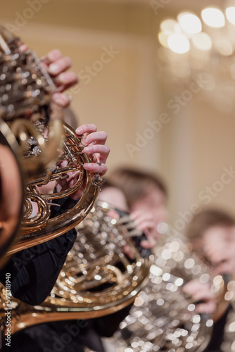 Multiple French horn players of a French horn ensemble during a live performance