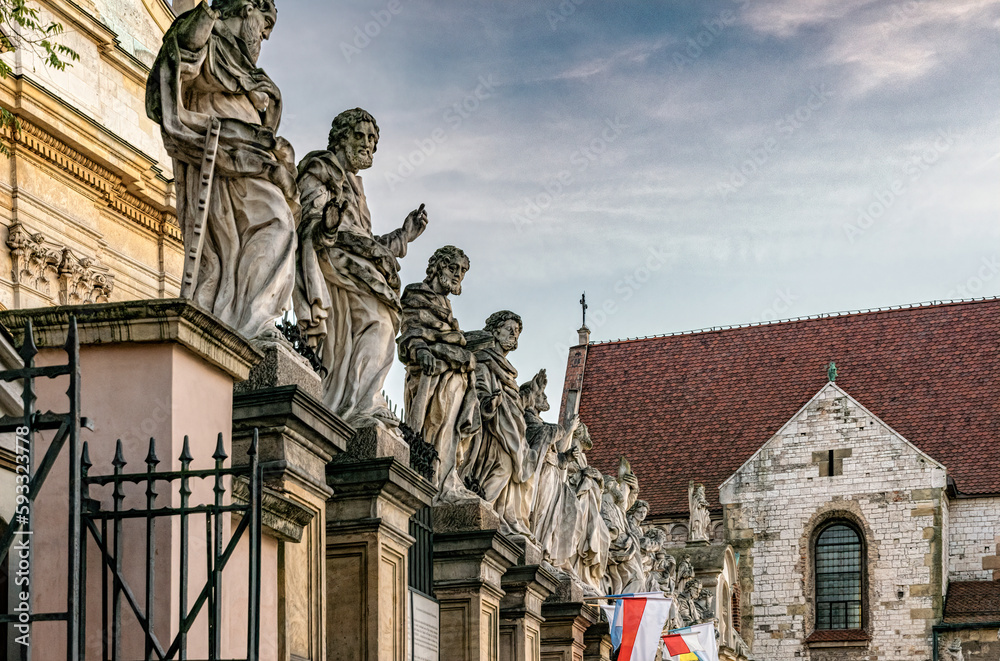 Fototapeta premium Krakow, Poland - November 12, 2022: Beautiful gothic facade and statues of the catholic Church of the Holy Apostles Peter and Paul in the historical district of Krakow