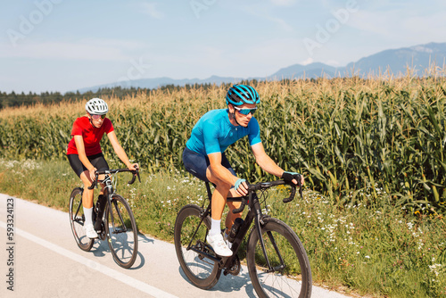 Man and woman couple road cycling on race bike outdoor in nature