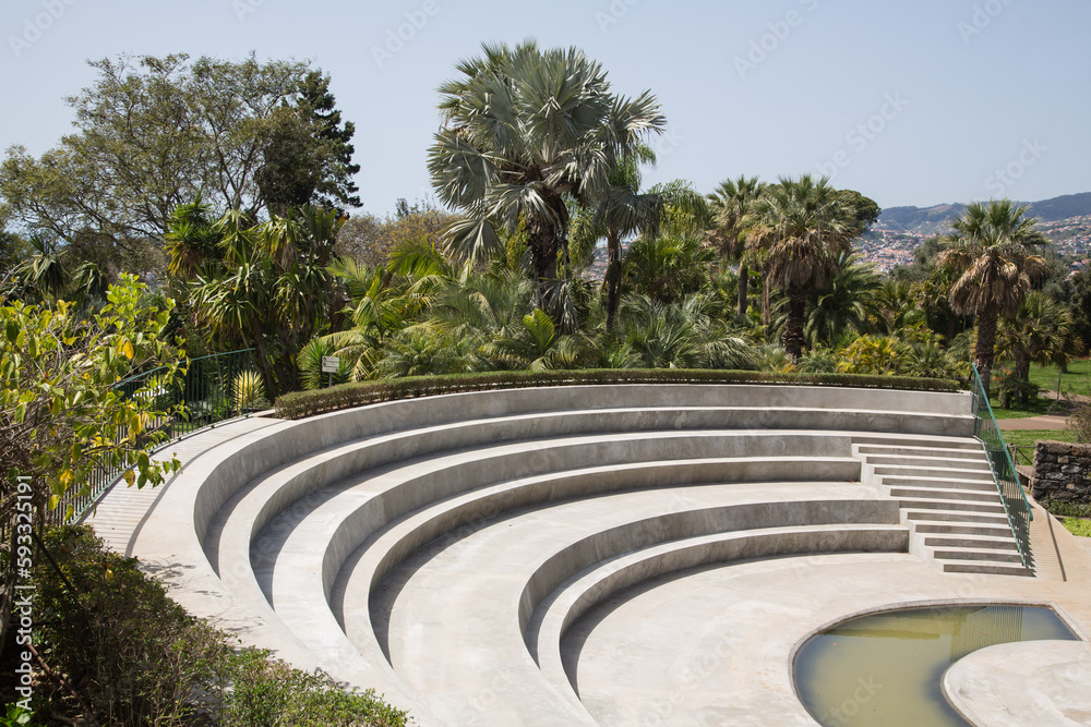 Nature, garden and modern landscape architecture in Madeira, Portugal-The hillside amphitheater made of concrete stone surrounded by palm trees and tropical plants, botanical garden of Funchal Monte Nature, garden and modern landscape architecture in Madeira, Portugal-The hillside amphitheater made of concrete stone surrounded by palm trees and tropical plants, botanical garden of Funchal Monte