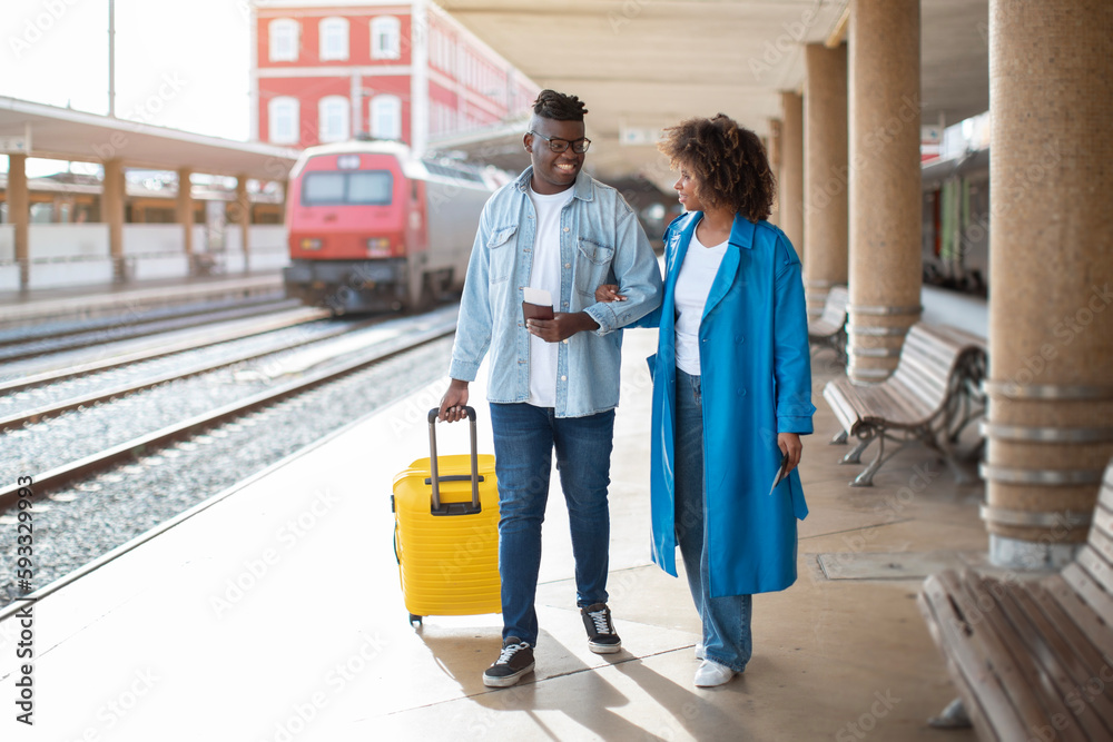 Going To Train. Happy Black Couple Walking With Suitcase At Railway Station Going To Train. Happy Black Couple Walking With Suitcase At Railway Station