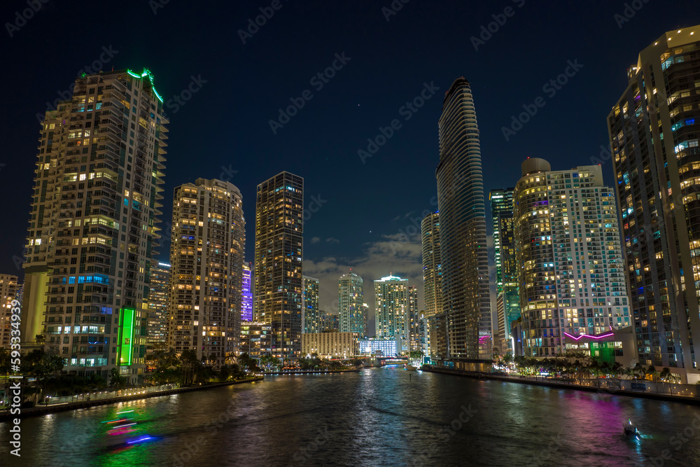Night urban landscape of downtown district of Miami Brickell in Florida, USA. Skyline with brightly illuminated high skyscraper buildings in modern american megapolis Night urban landscape of downtown district of Miami Brickell in Florida, USA. Skyline with brightly illuminated high skyscraper buildings in modern american megapolis