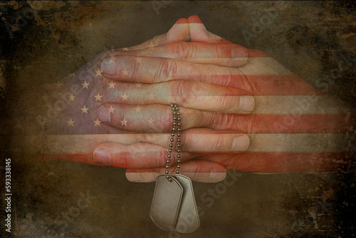 American flag pattern on praying hands holding military dog tags