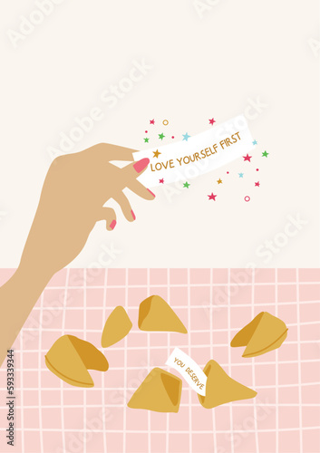 Fortune cookies with woman hand holding the note with prediction.