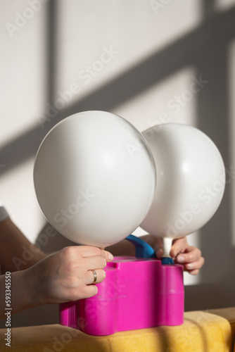 inflate balloons. process of inflating balloons with air.
