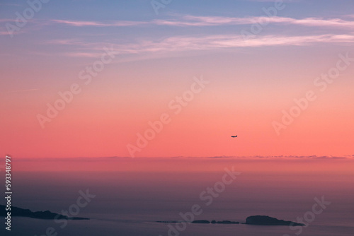 Plane flying during the sunset © Zan