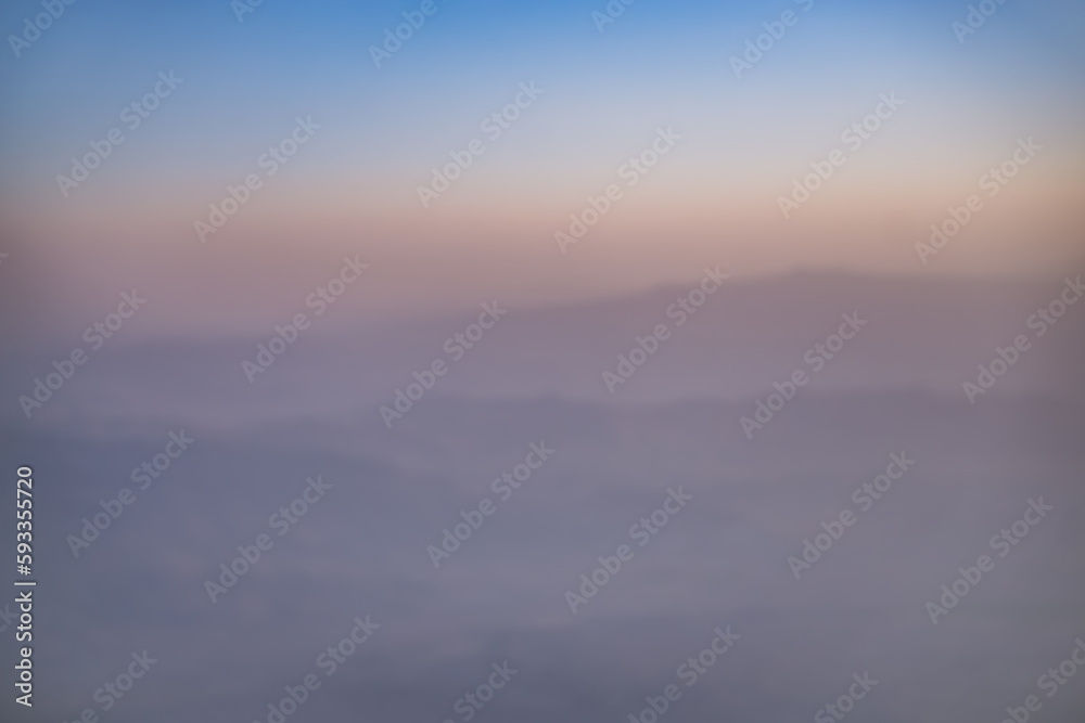 Abstract view of blurry hills and mountain ranges at sunset, warm sunset hues in the mountains in the evening