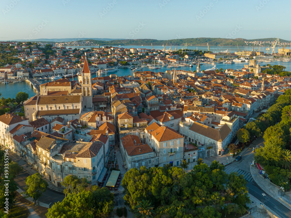 Aerial shot of magnificent Venetian city on the Adriatic Sea - Trogir, Croatia. Morning shot of old town Trogir with orange tiled roofs